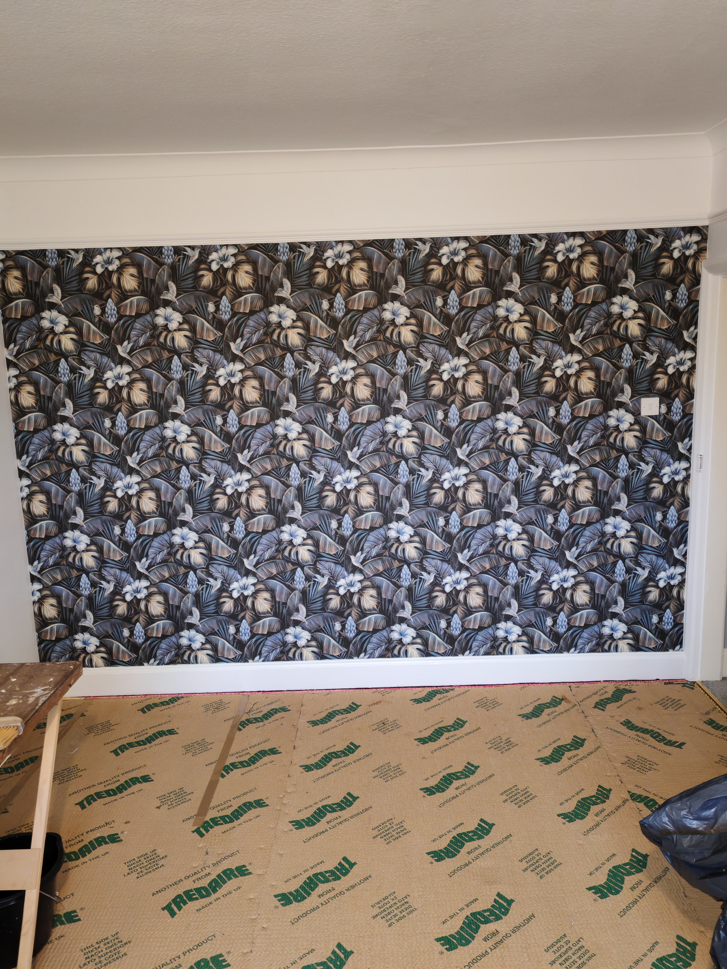 Feature wall fully papered, mid-job view